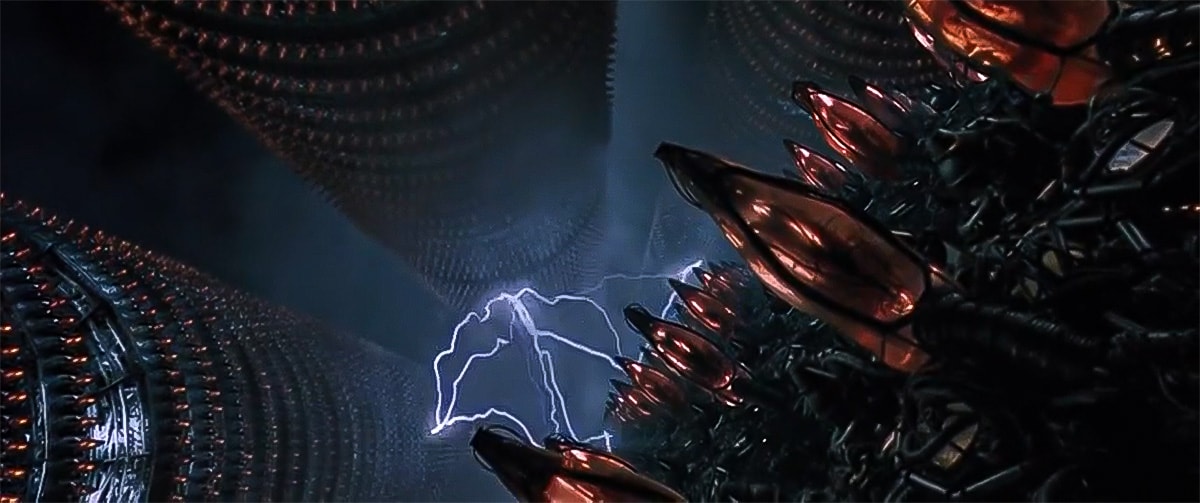 Mátrix 1 filmjelenet, ahol Neo (Keanu Reeves) felébred, és sok embert lát burokban, mesterséges tartályokban.